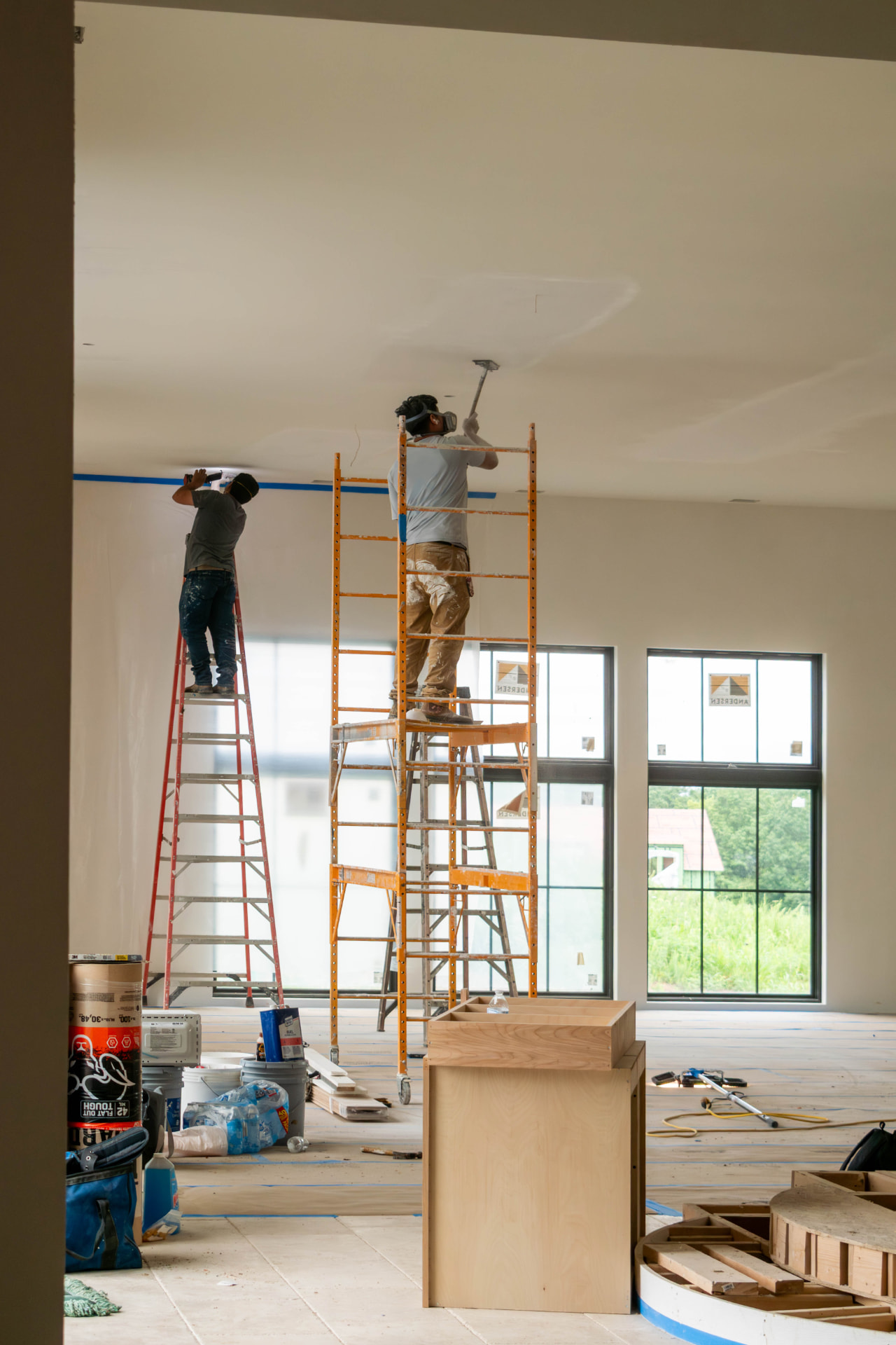 Bax crew finishing drywall and ceiling work on a jobsite